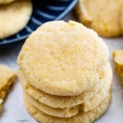 Stack of four cornmeal cookies with more scattered around