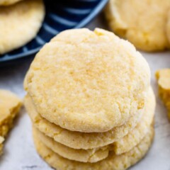 Stack of four cornmeal cookies with more scattered around