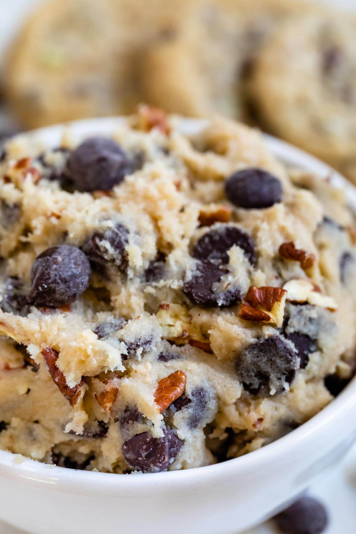 Close up of edible cookie dough with chocolate chunks and pecans