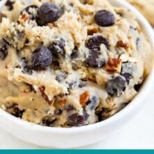 Edible cookie dough in a white dish with cookies behind it and recipe title on bottom of photo