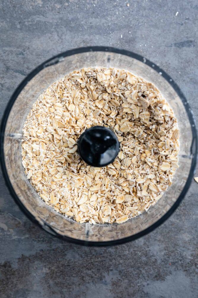 Overhead shot of old fashioned oats in a food processor after being processed