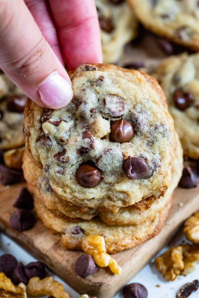 Hand picking up a toll house cookie