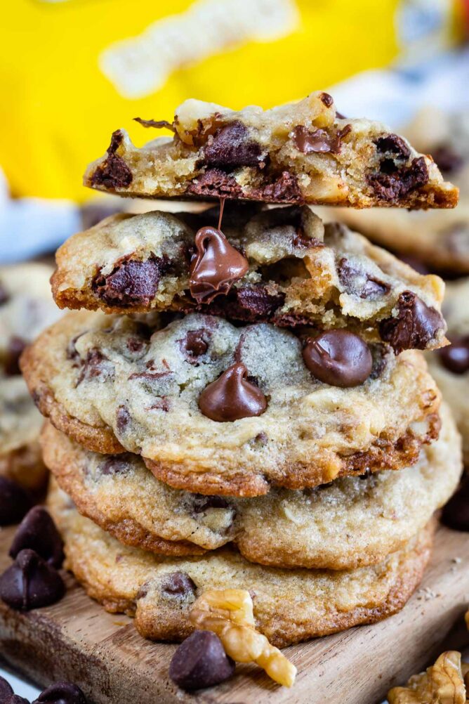 Toll house cookies stacked on eachother with top one cut in half to show inside