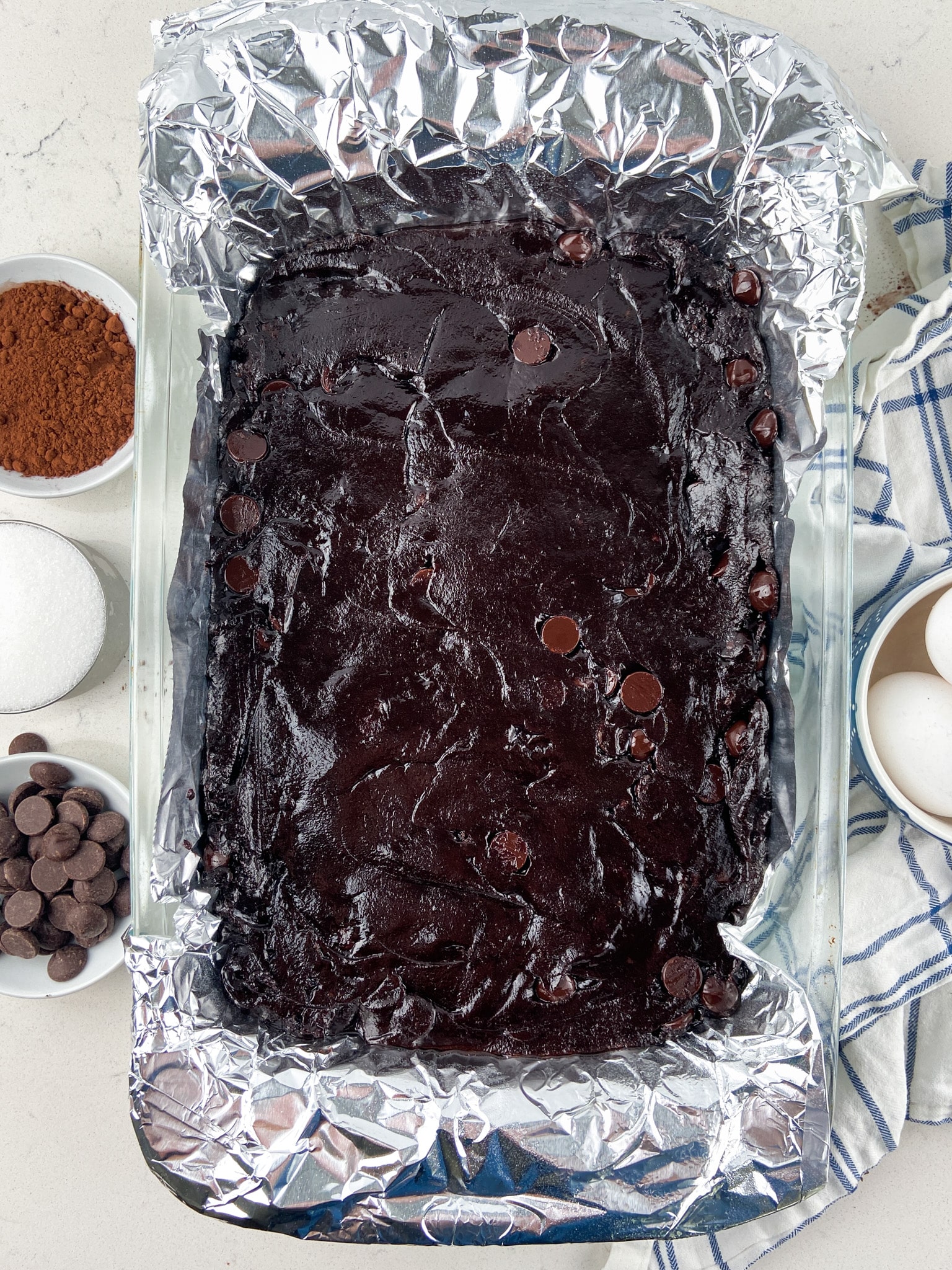 brownie batter in pan with foil