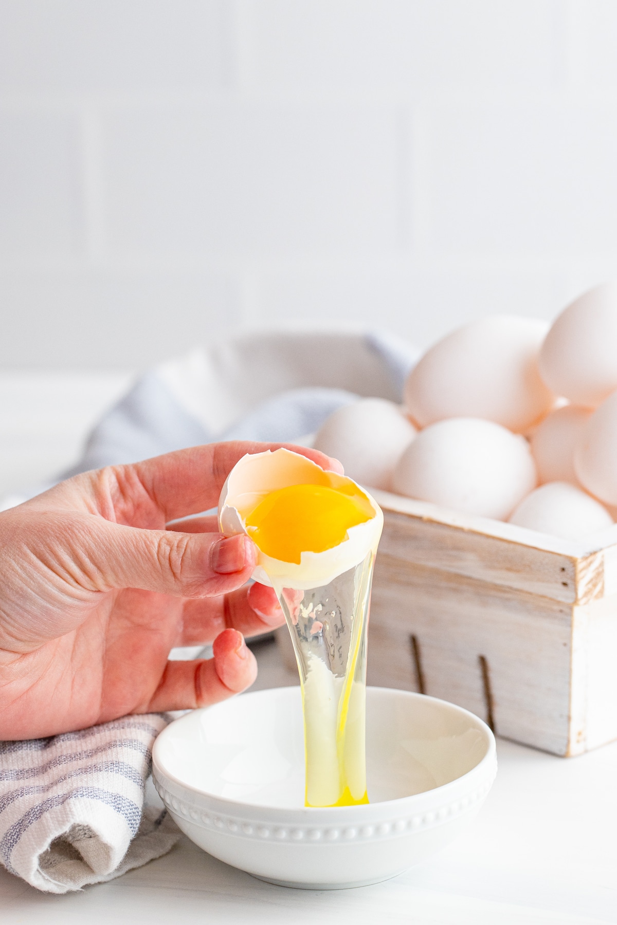 One egg being separated into a small bowl