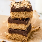 Three peanut butter cookie fudge bars stacked on eachother