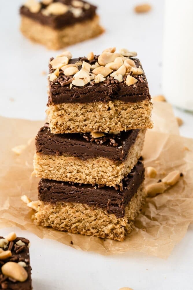 Three peanut butter cookie fudge bars stacked on eachother