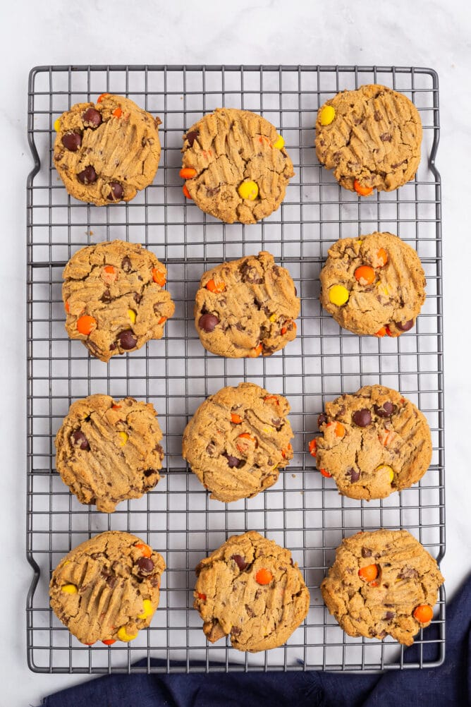 Overhead shot of Reese's overload peanut butter cookies on a wire cooling rack