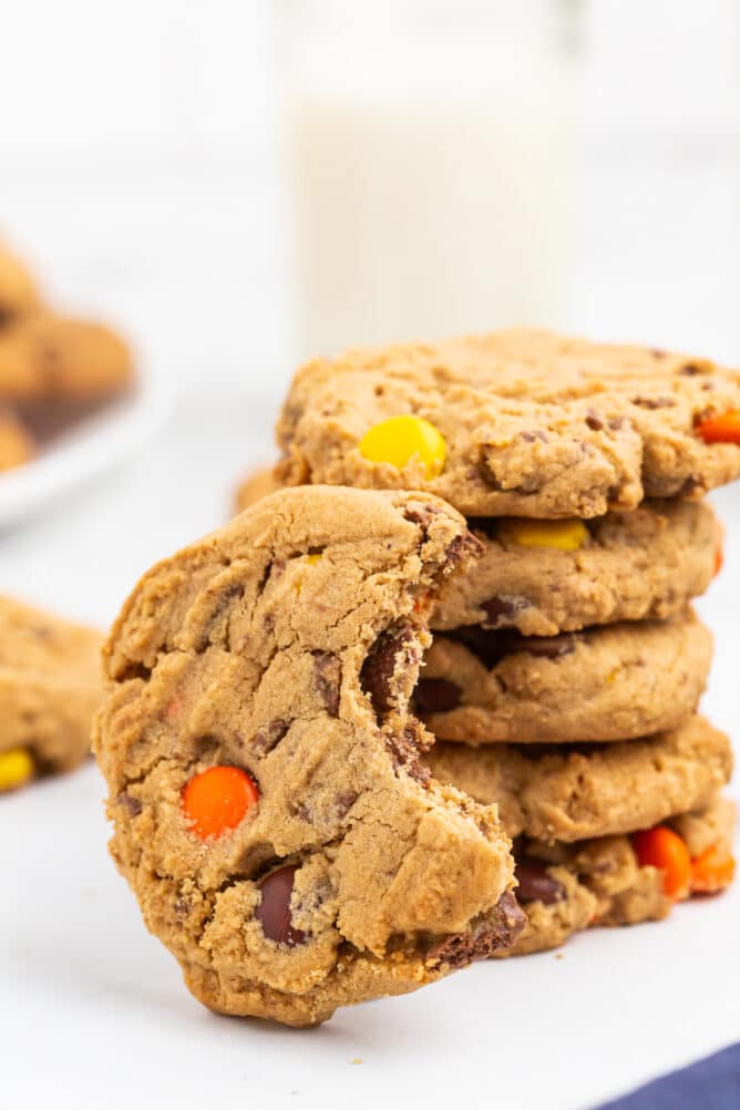 Stack of Reese's overload peanut butter cookies with one cookie missing a bite from it