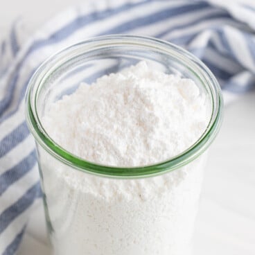Powdered sugar in a clear tall glass