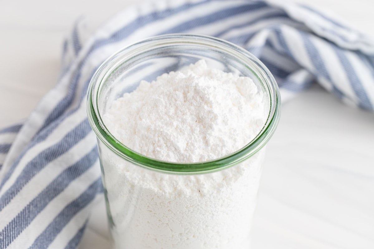 Powdered sugar in a clear tall glass