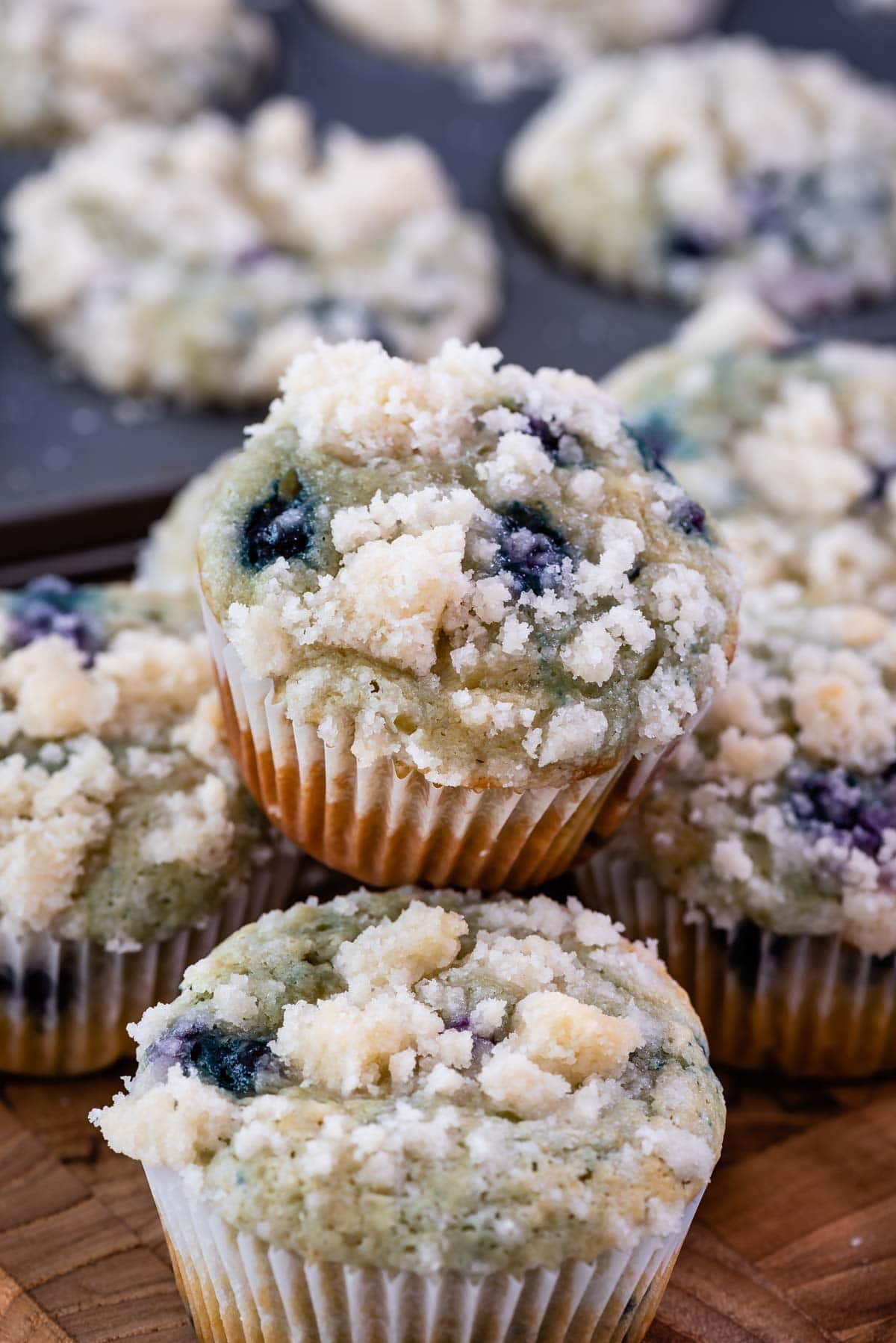 blueberry muffin sitting on stack of muffins