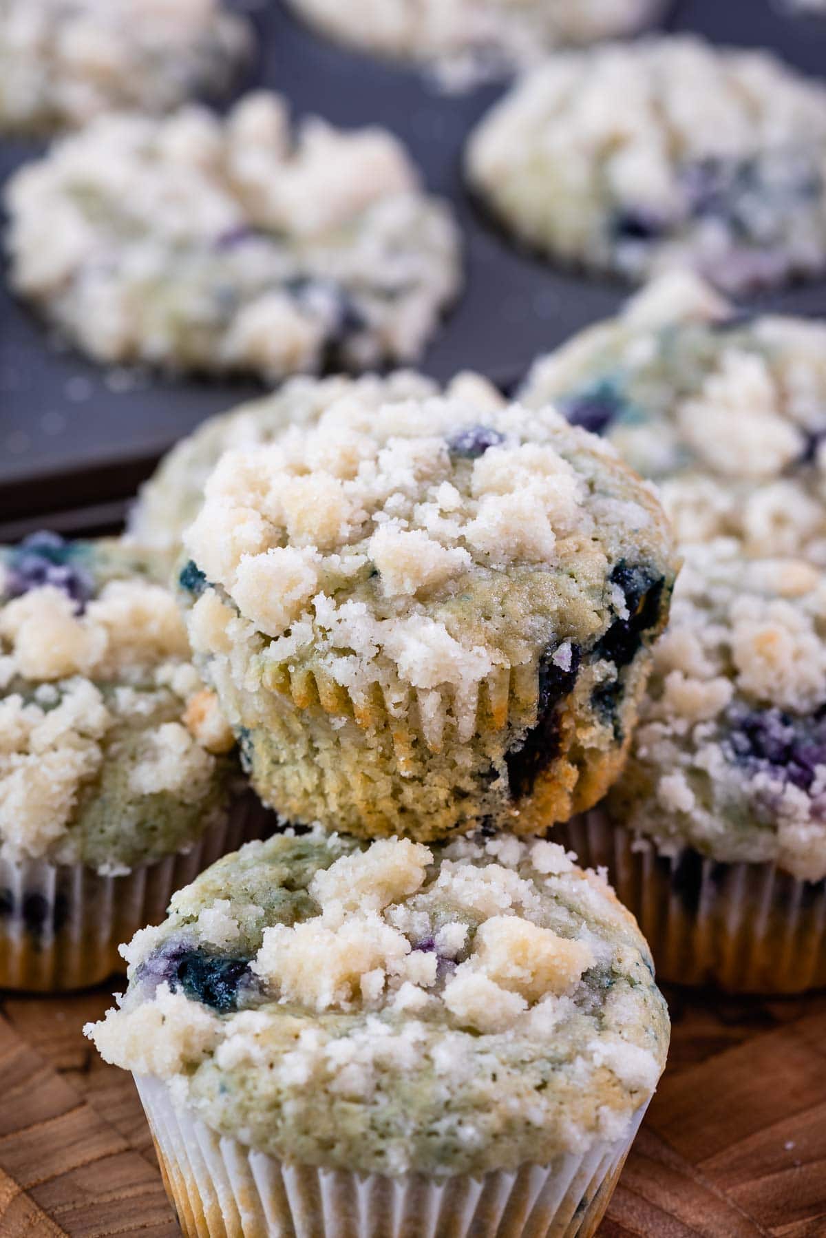 blueberry muffin sitting on stack of muffins