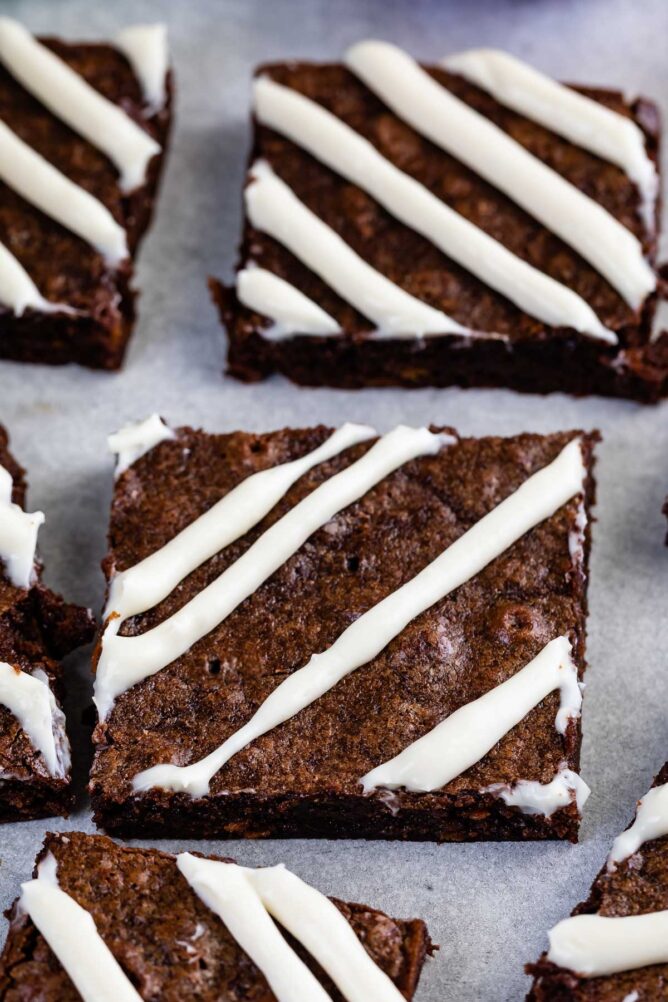 Close up shot of carrot cake brownies cut into squares with a cream cheese glaze