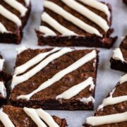 Close up shot of carrot cake brownies cut into squares with a cream cheese glaze