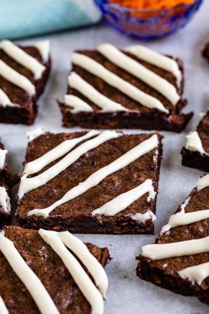 Close up shot of carrot cake brownies cut into squares with a cream cheese glaze