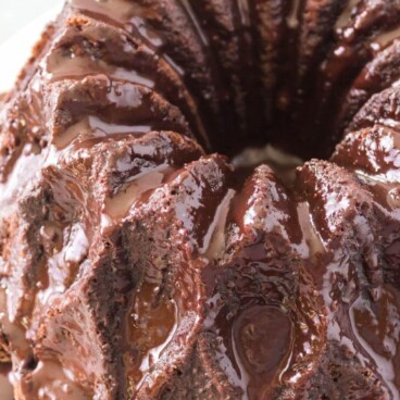 Overhead view of easy chocolate bundt cake covered in chocolate ganache and recipe title on top of image