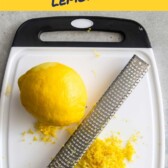 Overhead shot of lemon being zested over a cutting board with blog title on top of image