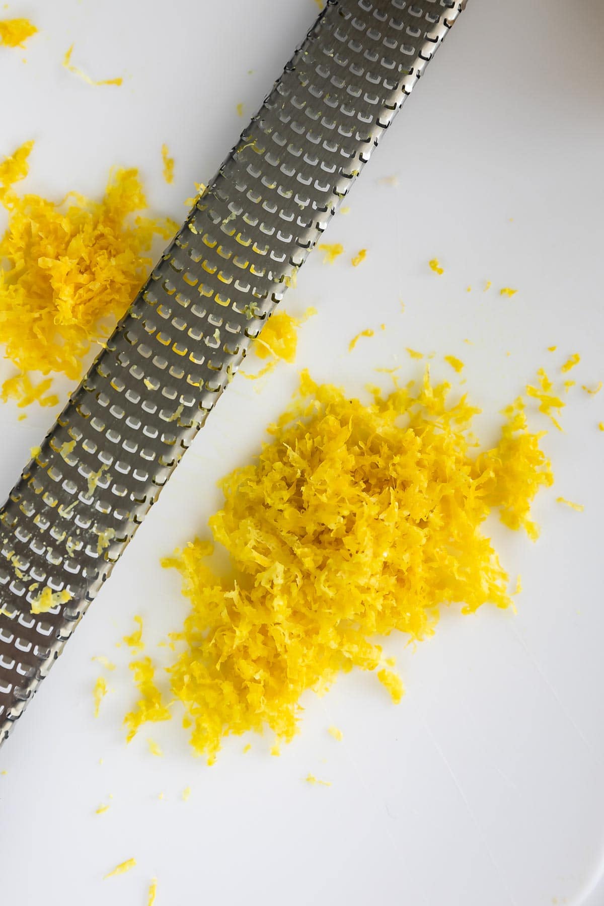 Close up shot of lemon zest on a white cutting board