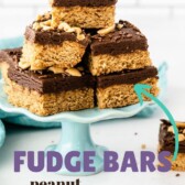 Peanut butter cookie fudge bars cut into squares and placed on a turquoise cake stand and recipe title on image