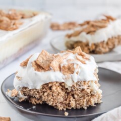 One slice of cinnamon toast crunch poke cake on a plate