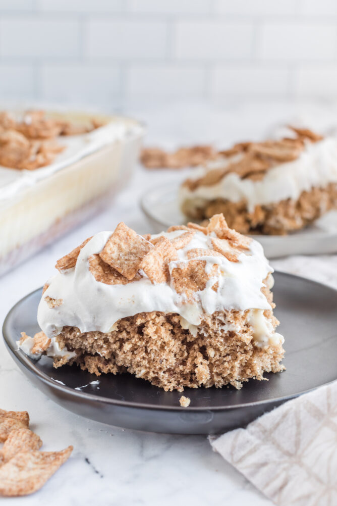 One slice of cinnamon toast crunch poke cake on a plate