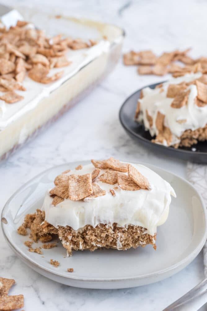 One slice of cinnamon toast crunch poke cake on a plate