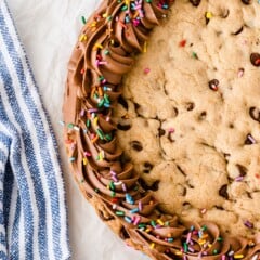 Overhead view of cookie cake with chocolate icing border and rainbow sprinkles