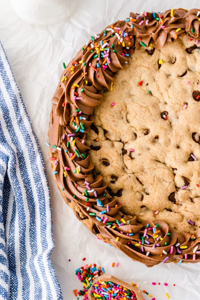 Overhead view of cookie cake with chocolate icing border and rainbow sprinkles