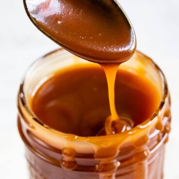 jar of caramel with spoon drizzling