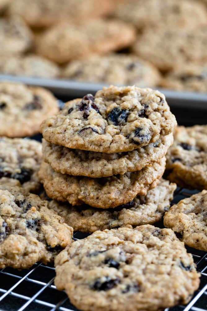 Lots of oatmeal raisin cookies on a wire cooling rack