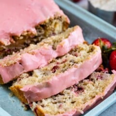 sliced quick bread with pink frosting on teal tray