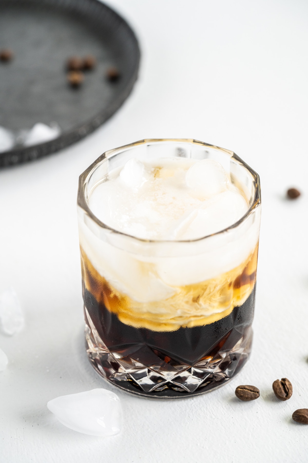 White russian in a cocktail glass before being mixed together