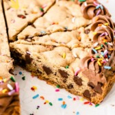 Cookie cake with one slice missing and recipe title on bottom of photo