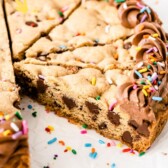 Cookie cake with one slice missing and recipe title on bottom of photo