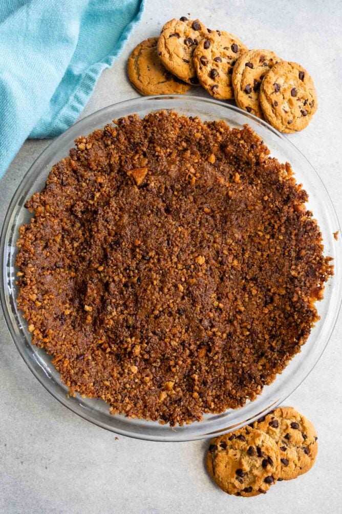 Overhead shot of chocolate chip cookie crust with chocolate chip cookies around it