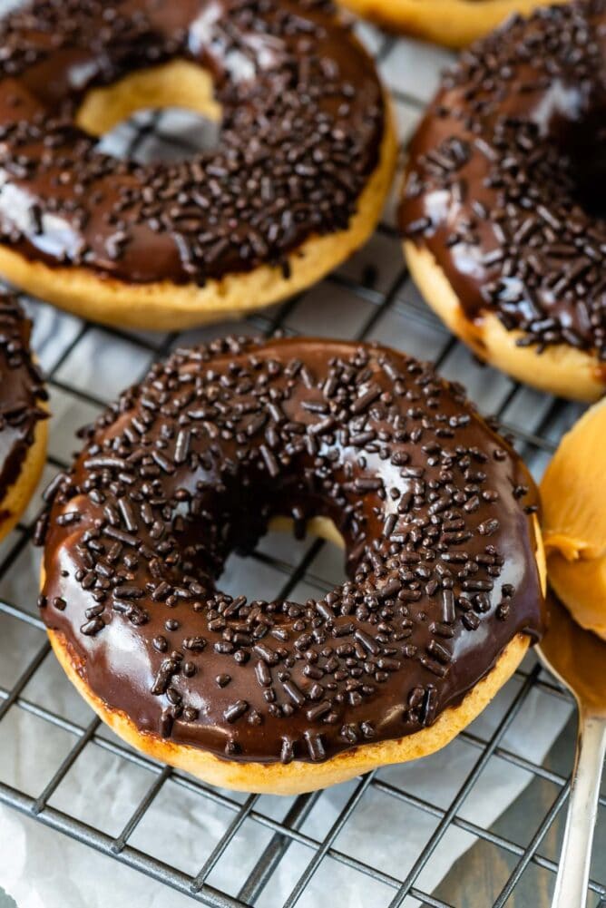 Overhead shot of peanut butter baked donuts with chocolate sprinkles on top