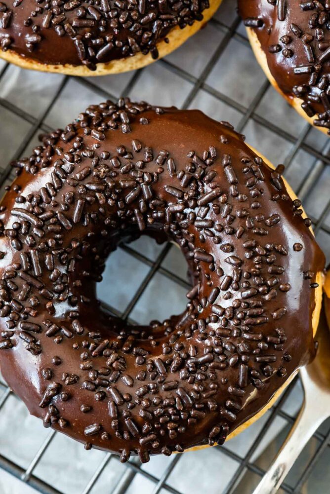 Close up overhead shot of peanut butter baked donut with chocolate icing and sprinkles