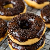 Stack of two peanut butter baked donuts with chocolate icing and sprinkles