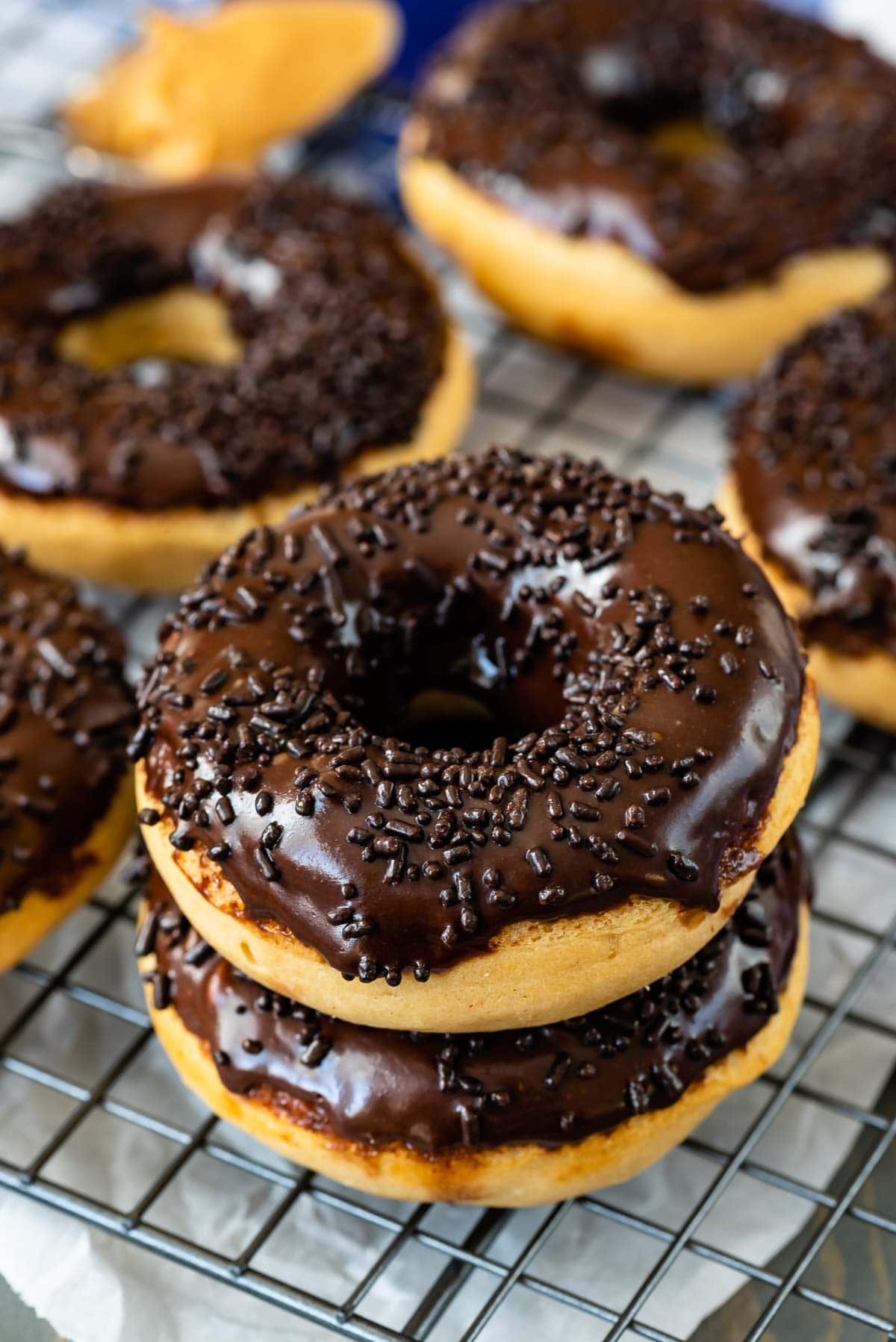 Stack of two peanut butter baked donuts with chocolate icing and sprinkles