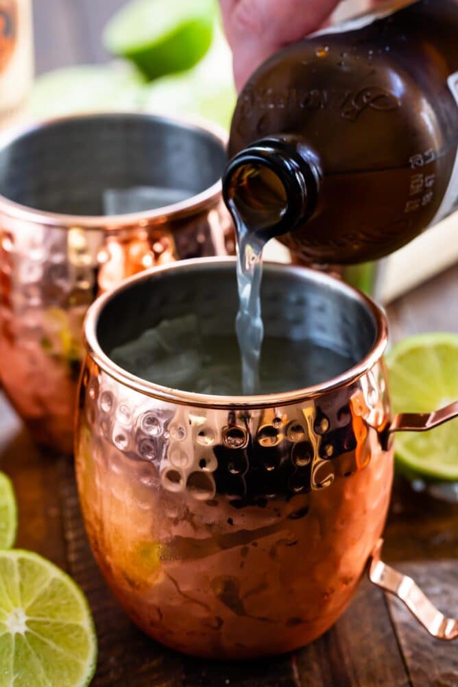 Ginger beer being poured into moscow mule mug