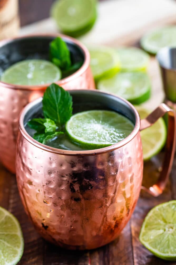 Two moscow mules topped with mint and lime