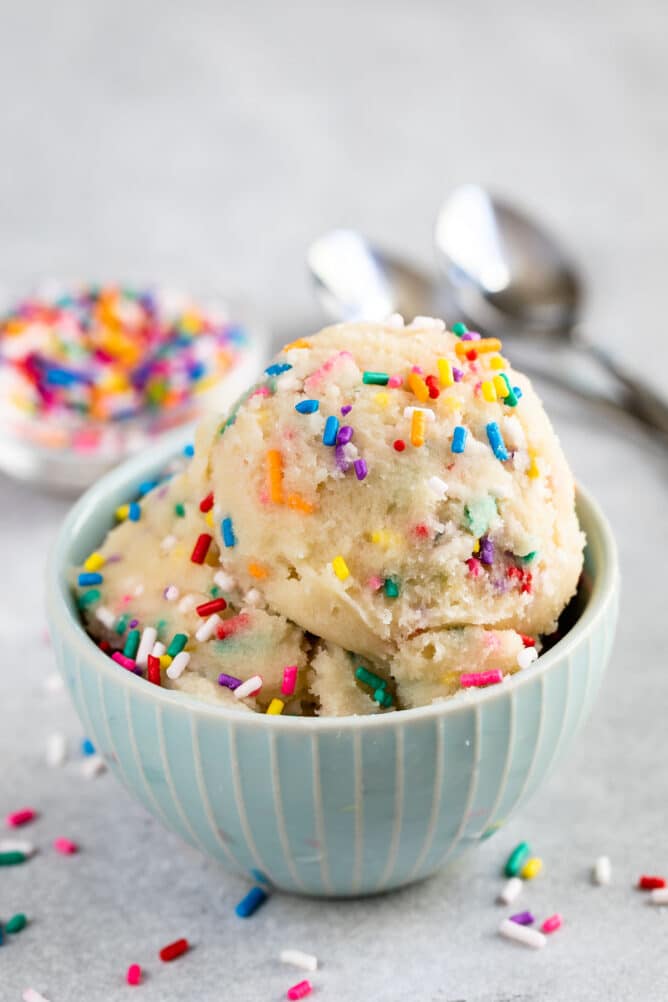 Small bowl full of edible sugar cookie dough with rainbow sprinkles