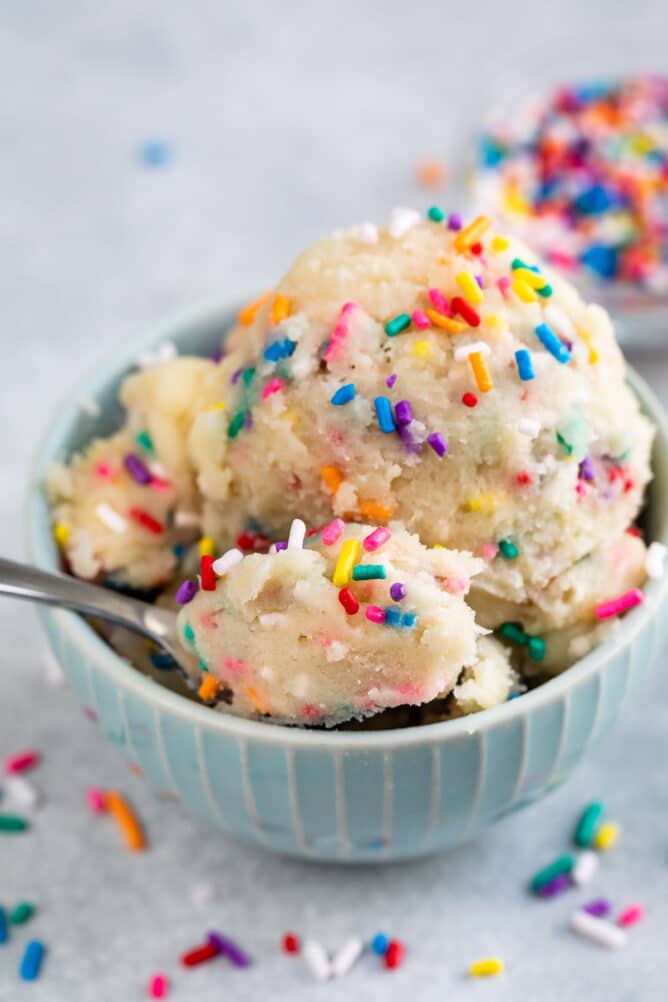 Small bowl full of edible sugar cookie dough with rainbow sprinkles