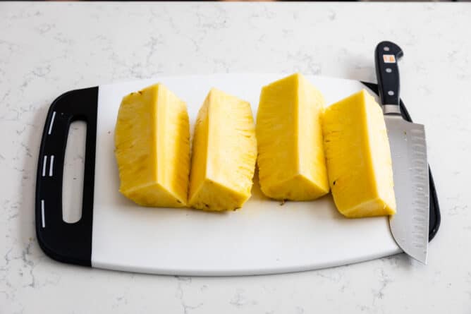 pineapple wedges on white cutting board