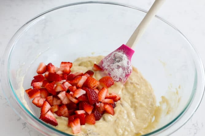 batter in bowl with chopped strawberries