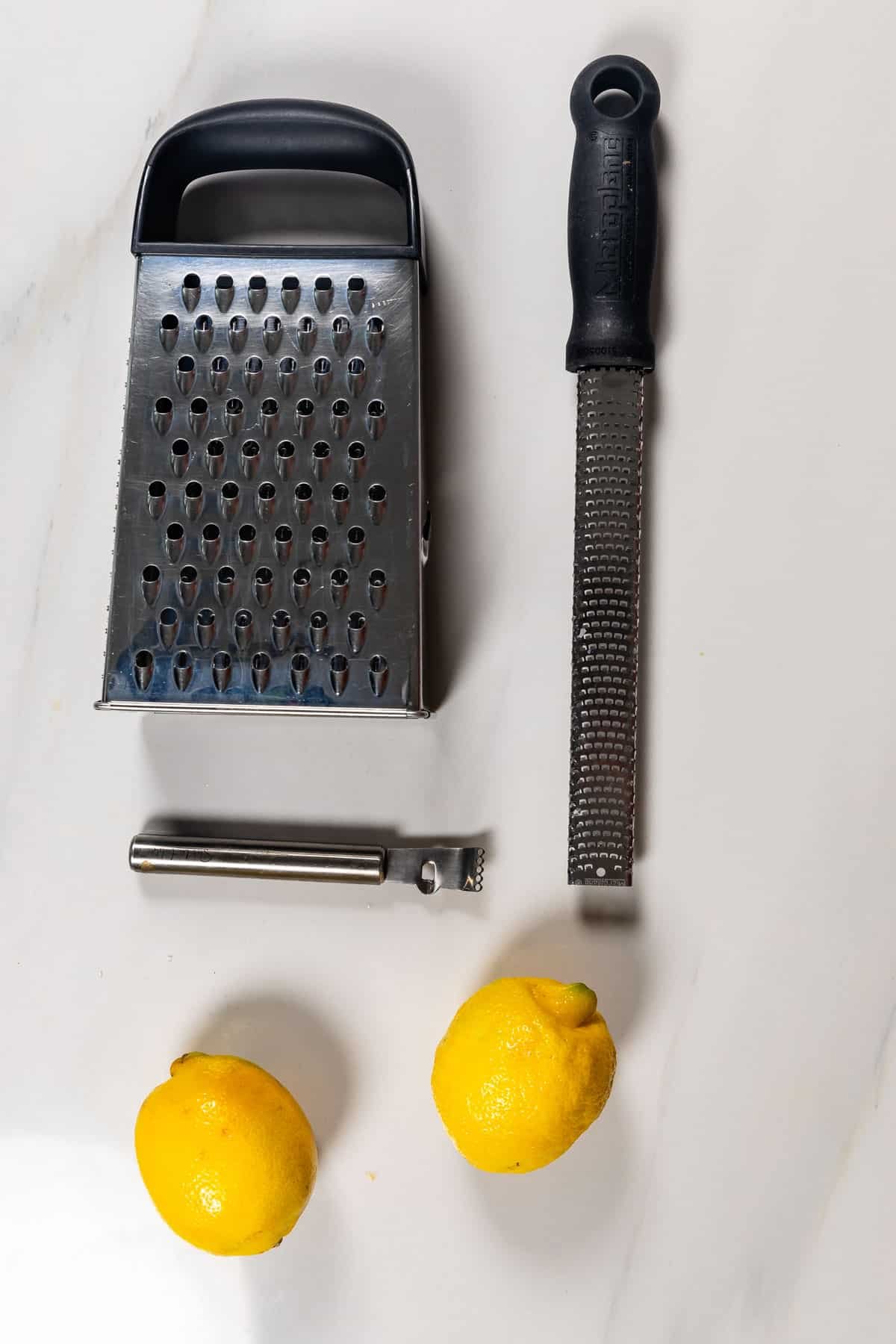 box grater, grater, and microplane with lemons