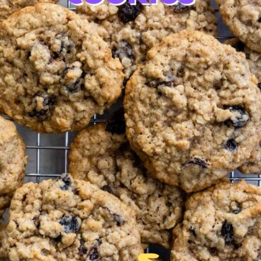 Overhead shot of oatmeal raisin cookies on wire cooling rack with recipe title on top of image