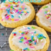 Five sugar cookies with icing and sprinkles on a wire cooling rack with recipe title on top of image