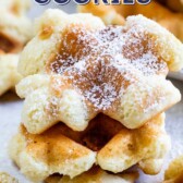 Stack of no bake waffle cookies with powdered sugar on top and recipe title on top of image